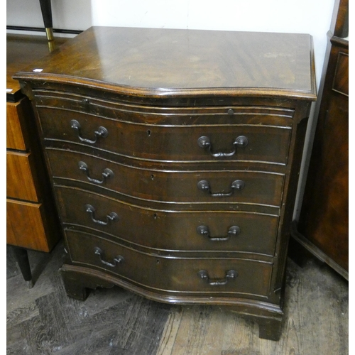 24 - Georgian style serpentine fronted brushing slide chest of four long drawers