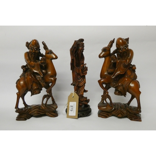 279 - A pair of Japanese root carvings of warriors mounted on deer and another carving of a sage on a circ... 