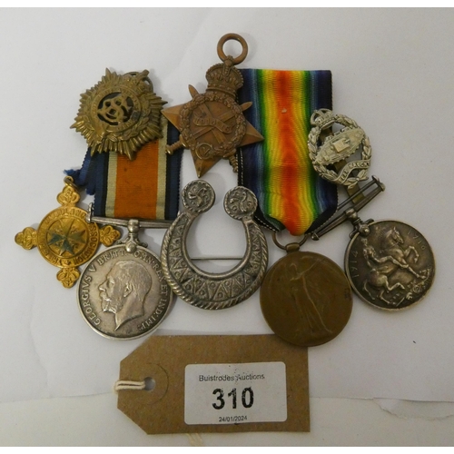 310 - A small collection of first world war medals and badges etc