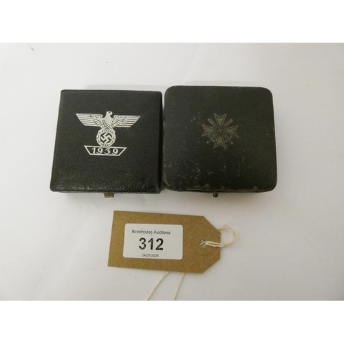 312 - Two boxed Nazi insignia -  the bar for the Iron Cross First Class World War II and the other War Mer... 