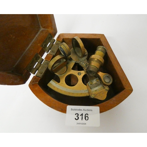 316 - A small brass sextant in original case