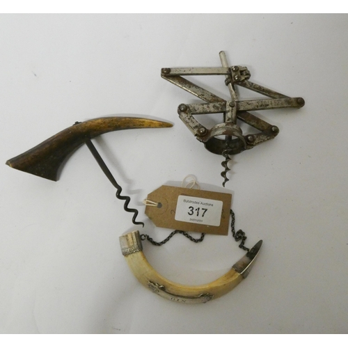 317 - Two old corkscrews and a fancy wine label with white metal mounts