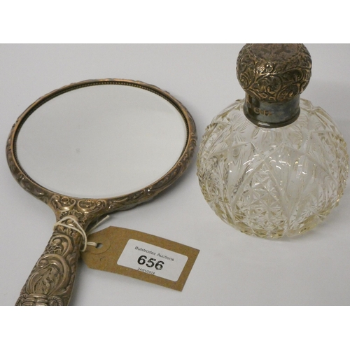 656 - A cut glass and silver mounted scent bottle and a silver backed hand mirror