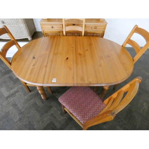 192 - A Pine dining room suite comprising oval table, four ladder back style chairs and a dresser with gla... 