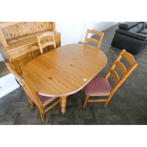 192 - A Pine dining room suite comprising oval table, four ladder back style chairs and a dresser with gla... 