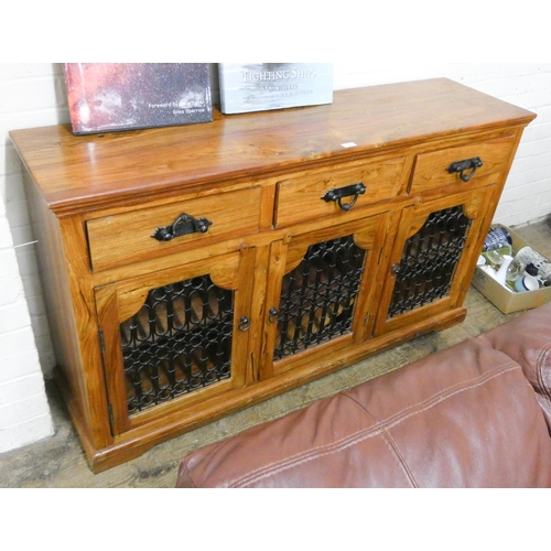 138 - A Jali teak sideboard with decorative iron doors and three drawers, 5' wide