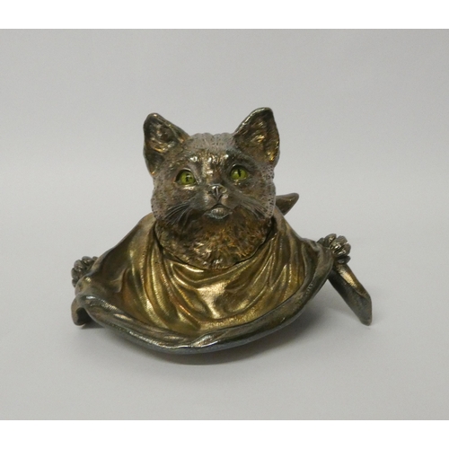 666 - A silver plated inkwell modelled as a cat with green glass eyes