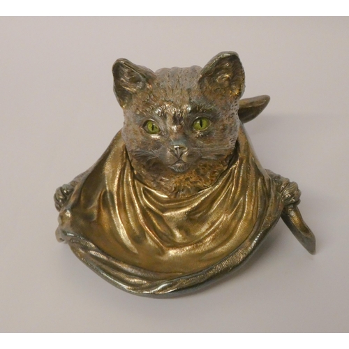 666 - A silver plated inkwell modelled as a cat with green glass eyes