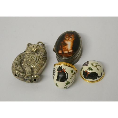 667 - A cat shaped rattle, modern silver pill box with cat motif to the lid and Halcyon Days enamel egg sh... 