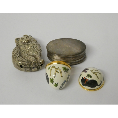 667 - A cat shaped rattle, modern silver pill box with cat motif to the lid and Halcyon Days enamel egg sh... 