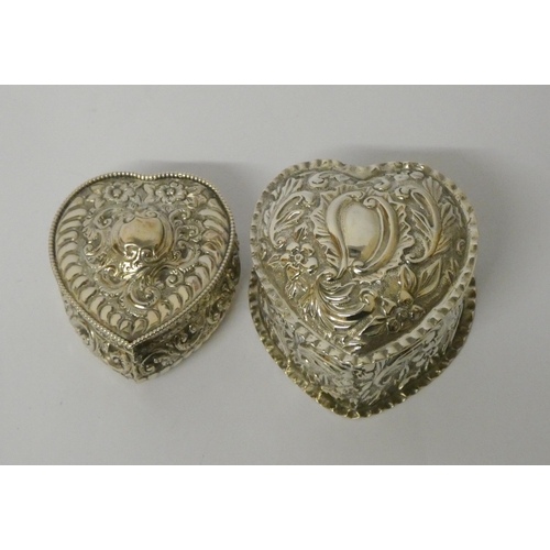 669 - Two hallmarked silver heart shaped trinket boxes with embossed decoration and hinged lids, largest m... 