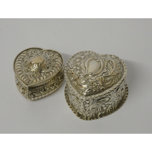 669 - Two hallmarked silver heart shaped trinket boxes with embossed decoration and hinged lids, largest m... 