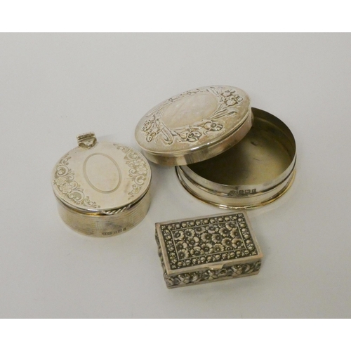 687 - Three hallmarked silver trinket boxes, the largest 6cms across, 2.3 troy ozs