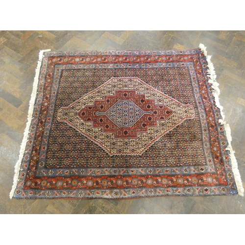 142 - A red and patterned wool pile Persian rug, 5' x 4'2