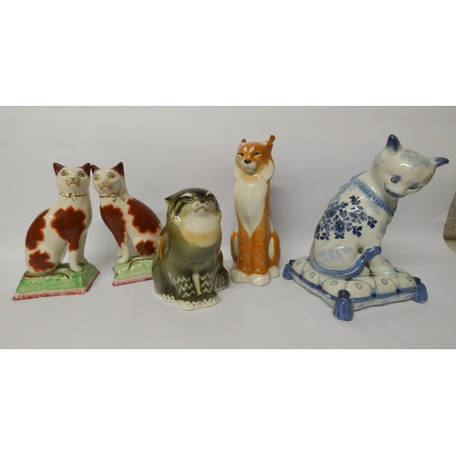 454 - Russian porcelain models of a cat and lynx, pair of Staffordshire cats and a modern Augustus Rex blu... 