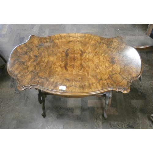 92 - A Victorian figured walnut shaped topped centre table on carved stretcher style base fitted with one... 