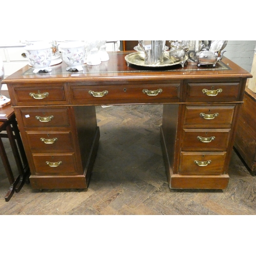 98 - An Edwardian mahogany kneehole pedestal desk fitted nine drawers with inset red leather top, 4' wide