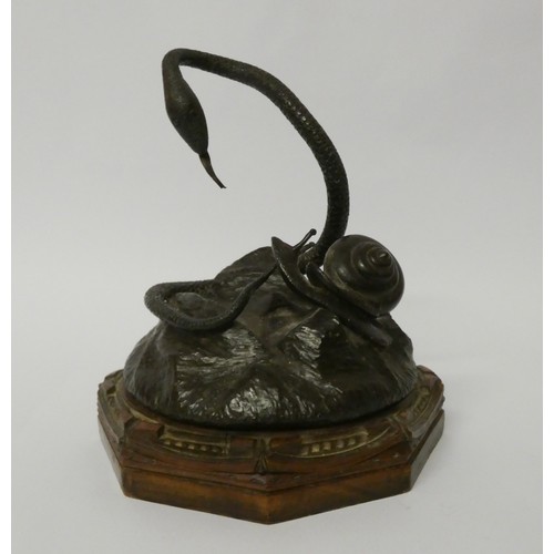 293 - A bronze of a snake and a snail on a hexagonal wooden base, approx 15cms high