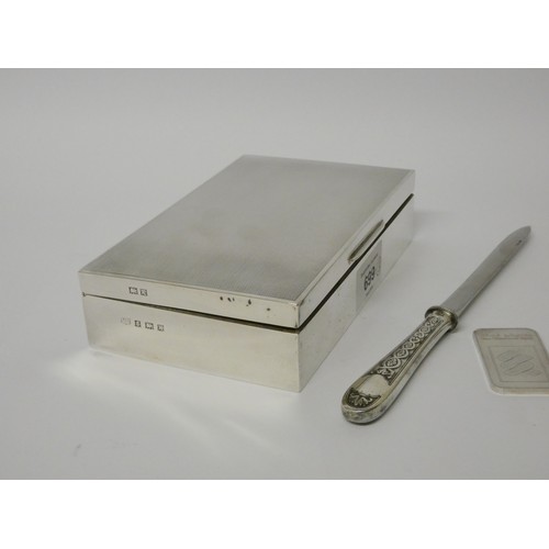 699 - A silver cigarette box, Birmingham 1959, silver 1oz ingot and a French white metal paper knife