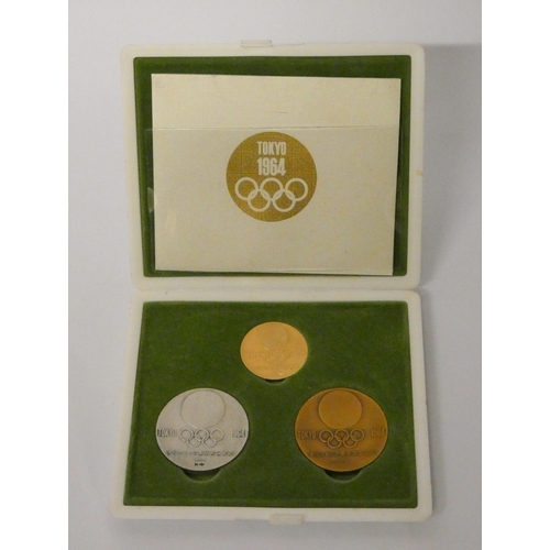 564 - Tokyo 1964 Olympics - Gold, silver, and copper commemorative medal set designed by Yusaku Kamekura a... 