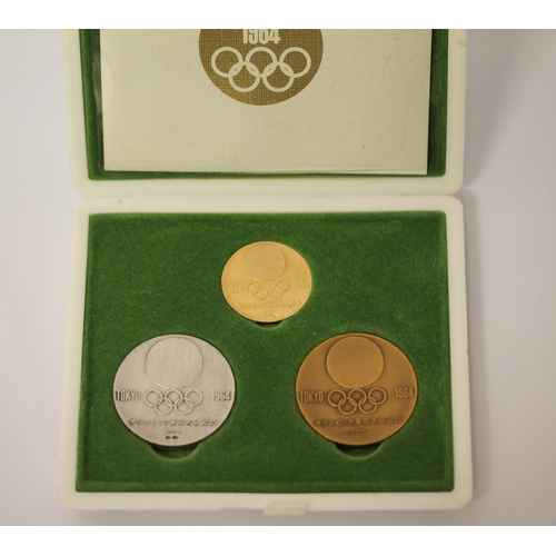 564 - Tokyo 1964 Olympics - Gold, silver, and copper commemorative medal set designed by Yusaku Kamekura a... 