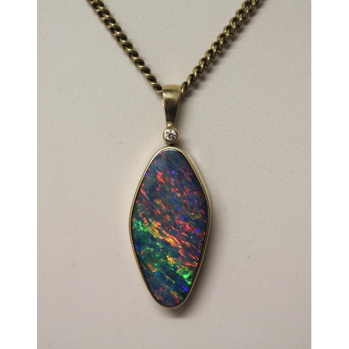 575 - An Australian boulder opal pendant, on  diamond set 14k gold setting,  on a 9ct yellow gold chain. C... 