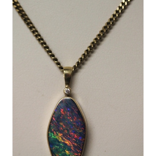 575 - An Australian boulder opal pendant, on  diamond set 14k gold setting,  on a 9ct yellow gold chain. C... 