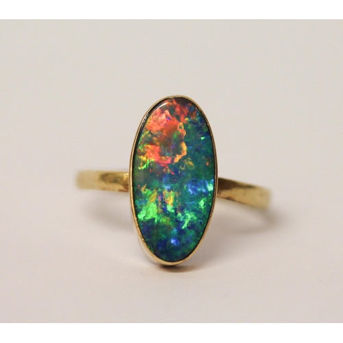 576 - Australian boulder opal oval dress ring, in rub over setting, to 14k  yellow gold band. Size U