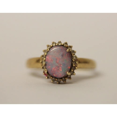 579 - Australian boulder opal and diamond oval cluster ring, on 14k yellow gold band, ring size T, weight ... 