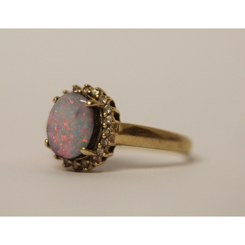 579 - Australian boulder opal and diamond oval cluster ring, on 14k yellow gold band, ring size T, weight ... 