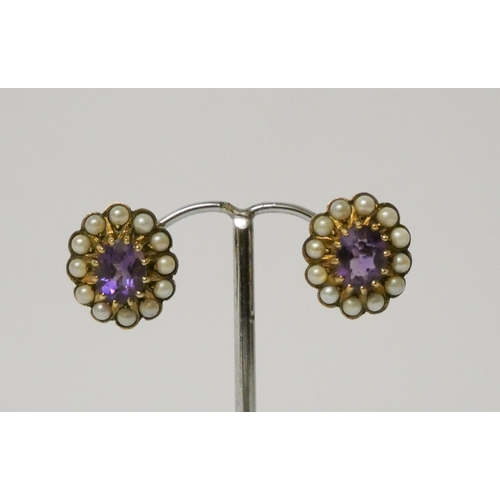 599 - A pair of amethyst and pearl oval cluster earrings, on hallmarked 9ct gold settings and posts.