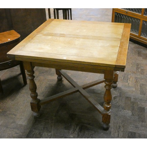 148 - An oak drawer leaf dining table on turned legs with cross stretchers, 3' square