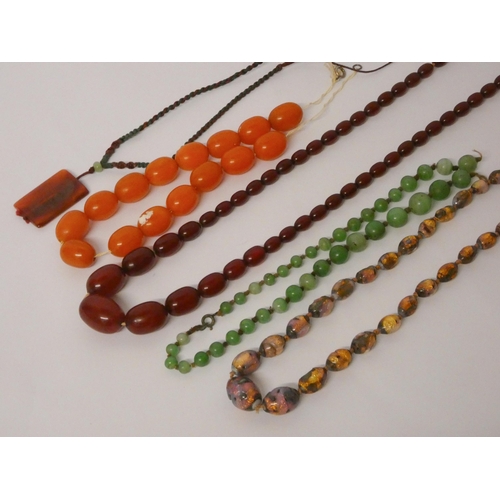 612 - A vintage graduated row of cherry amber beads, opalescent glass beads and others. Weight of cherry a... 