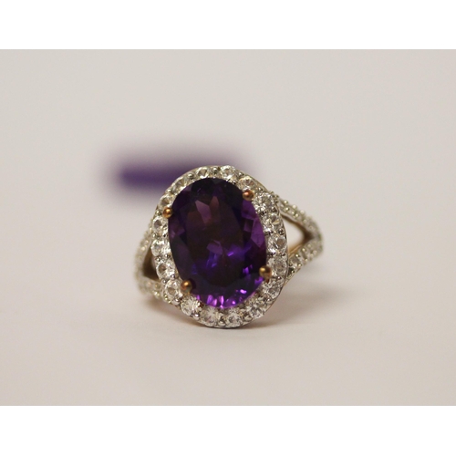 634 - Large amethyst and zircon dress ring, on 9ct gold shank, as new with box and tags. Ring Size L. weig... 