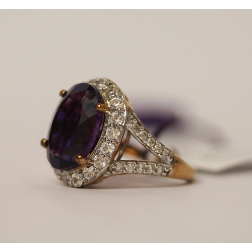 634 - Large amethyst and zircon dress ring, on 9ct gold shank, as new with box and tags. Ring Size L. weig... 