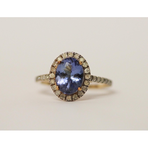 639 - 9ct gold oval tanzanite and diamond cluster ring, ring size L. As new with certificate