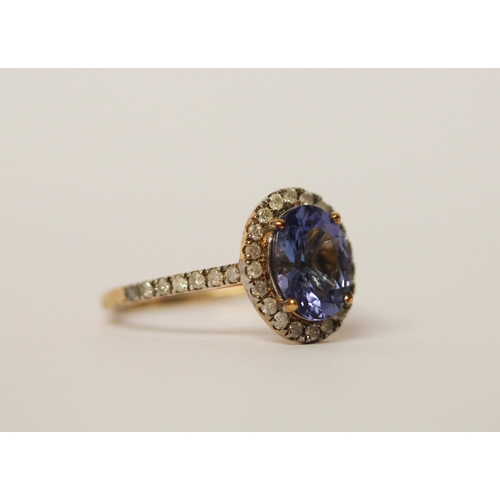 639 - 9ct gold oval tanzanite and diamond cluster ring, ring size L. As new with certificate