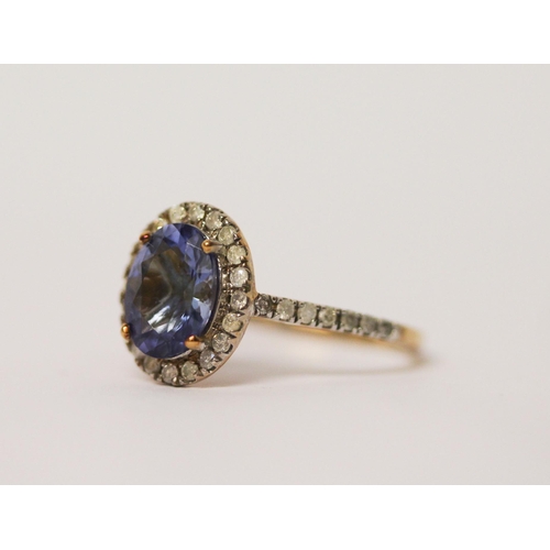 639 - 9ct gold oval tanzanite and diamond cluster ring, ring size L. As new with certificate