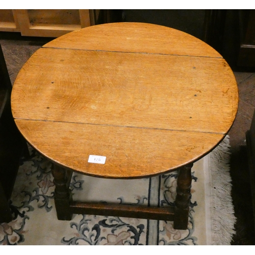 128 - A circular oak drop leaf coffee table on turned legs