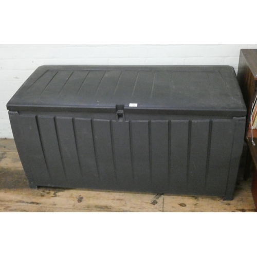 134 - A black plastic garden storage box, 4' wide