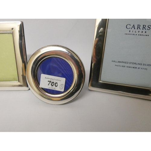 700 - Two matching rectangular silver photograph frames and similar circular frame with plain silver borde... 