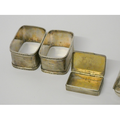 702 - Silver engraved cigarette case, a pair of silver rectangular napkin rings and a small silver engine ... 