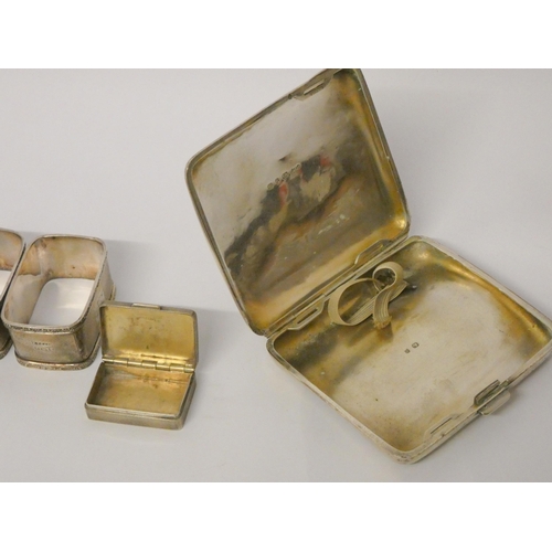 702 - Silver engraved cigarette case, a pair of silver rectangular napkin rings and a small silver engine ... 