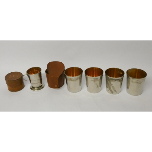 718 - A folding silver plated stirrup cup with gilded interior in leather case and a set of 4 silver plate... 