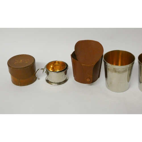 718 - A folding silver plated stirrup cup with gilded interior in leather case and a set of 4 silver plate... 