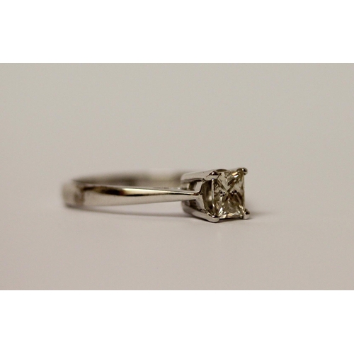 526 - A modern diamond engagement ring, the princess cut diamond weighing 0.76 carats on platinum band. Ha... 