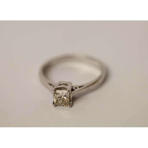 526 - A modern diamond engagement ring, the princess cut diamond weighing 0.76 carats on platinum band. Ha... 