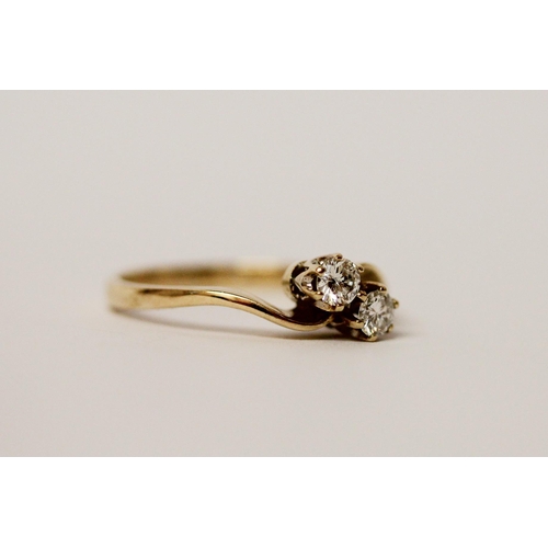 528 - A two stone diamond ring, in a twist setting on hallmarked 9ct gold band. Ring size M, weight 2.1g