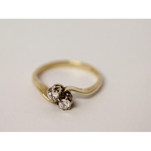 528 - A two stone diamond ring, in a twist setting on hallmarked 9ct gold band. Ring size M, weight 2.1g