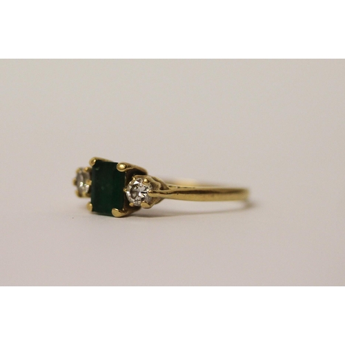 538 - A three stone emerald and diamond ring, on hallmarked 18ct yellow gold band, ring size N, weight 2.5... 